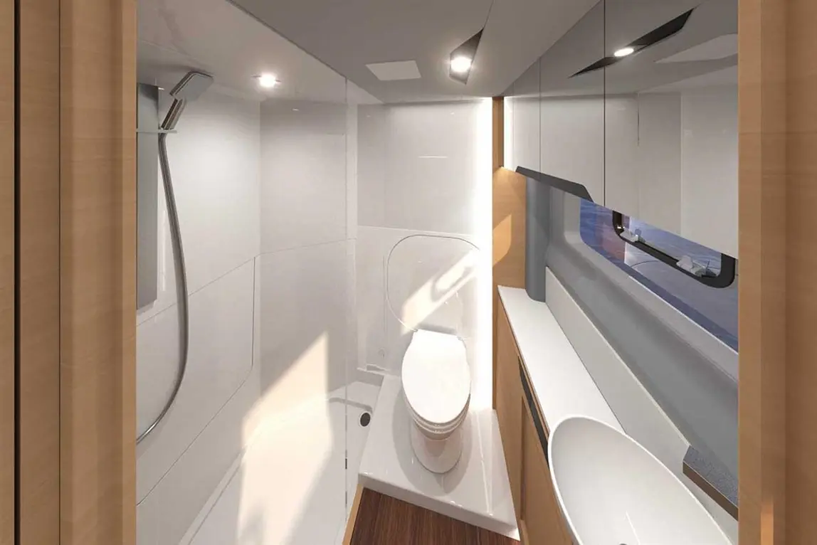 Modern bathroom with a shower, toilet, and sink, featuring sleek white and wooden surfaces, illuminated by ceiling lights.